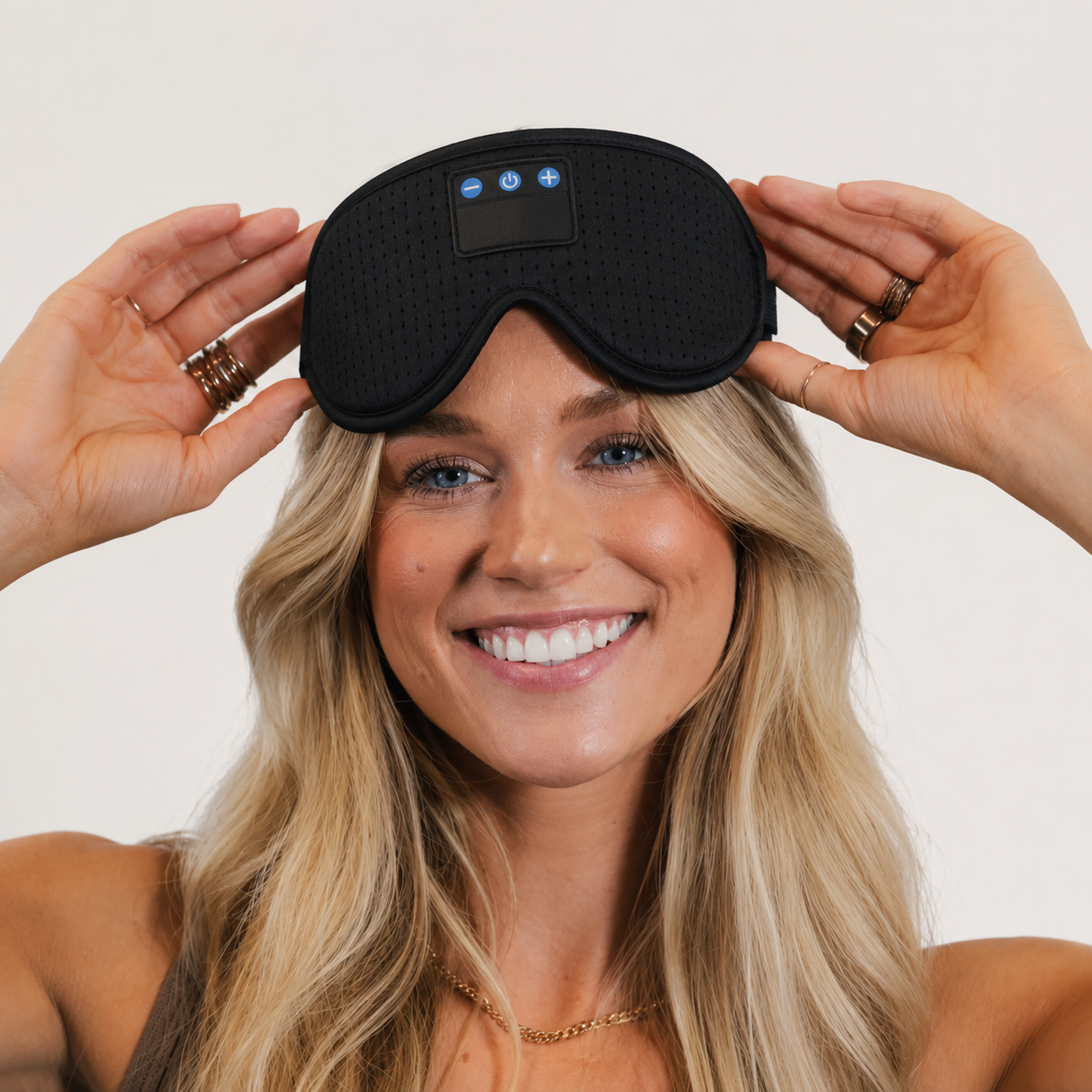Woman smiling, wearing sleep mask